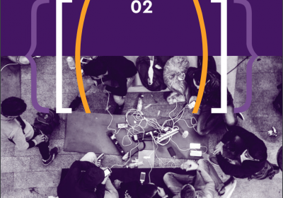 image of front cover of report, people gathered around a table with power cord in middle and electronic devices plugged in
