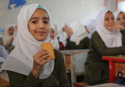  Aziza, seventh grade, eats a date bar in a classroom at Salah Al-Din School in Sana&#039;a city. Credit: WFP/Ahmed Haleem