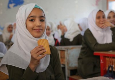 Aziza, seventh grade, eats a date bar in a classroom at Salah Al-Din School in Sana'a city. Credit: WFP/Ahmed Haleem 