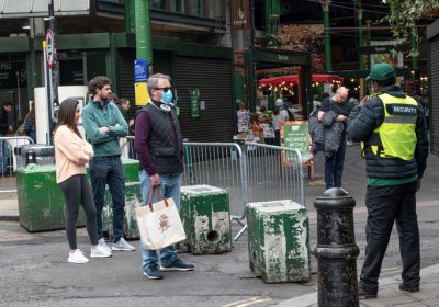 Security guard managing queue outside London&#039;s Borough Market during lockdown