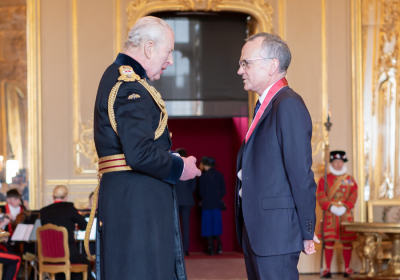 King Charles speaking to Liam Smeeth during investiture at Windsor Castle