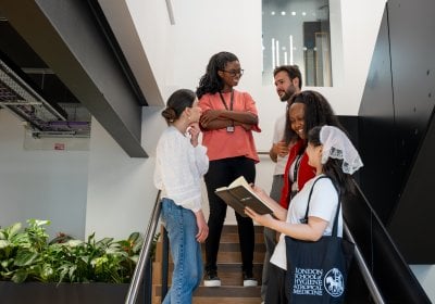 Student talking on the steps of Education Centre