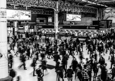 People in a busy train station in the UK