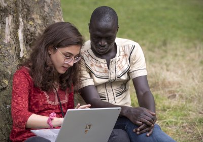 Male and female looking at a laptop