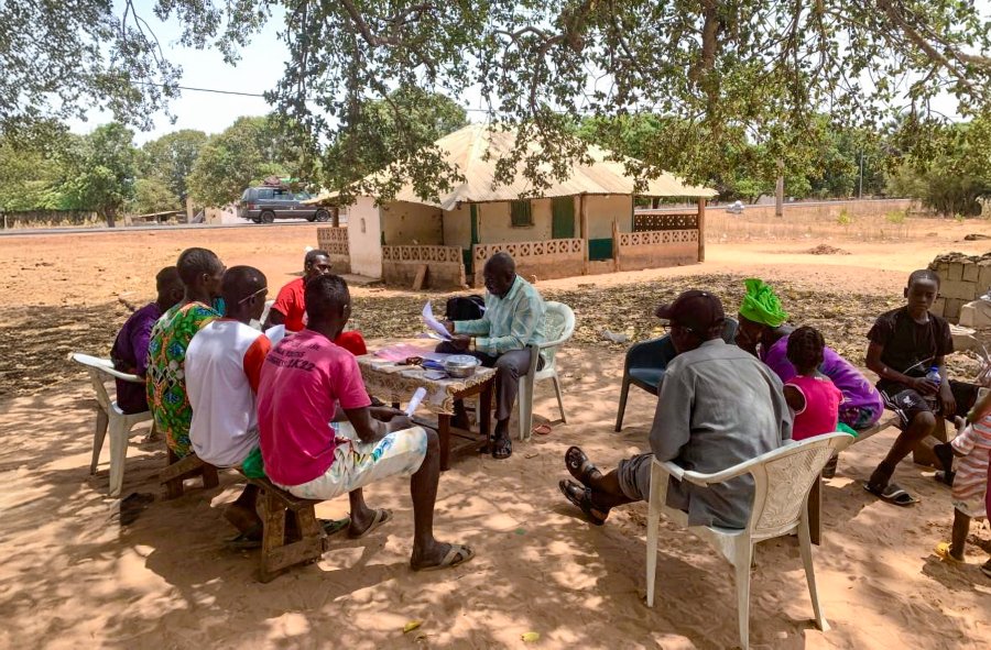 A researcher having an engagement with local community members in The Gambia
