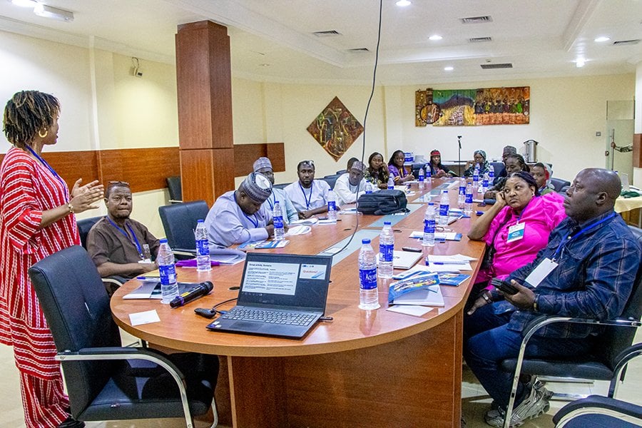 A group of individuals having a meeting in a seminar room