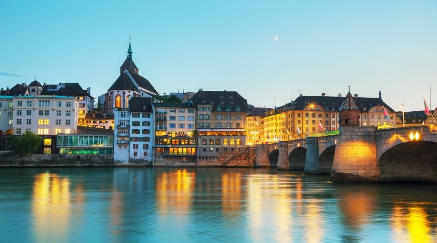 Photo of river, bridge and city buildings in Basel city centre.