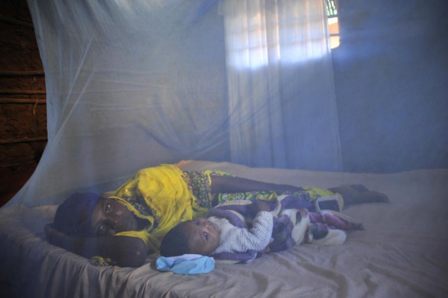 Leila Abdala, 30, with her baby Kairat, 5 months, lie under a bed net at their home in Mtwara, Tanzania