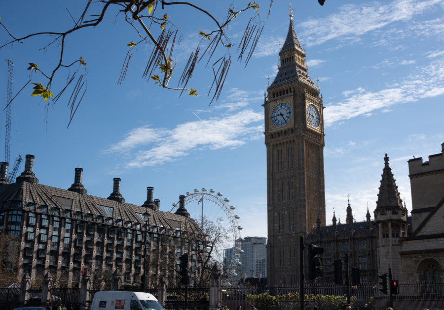 Image of Big Ben (large clock tower) & Houses of Parliament with the London Eye ferris wheel in the background