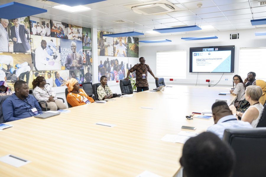 Individuals having a meeting in a seminar room