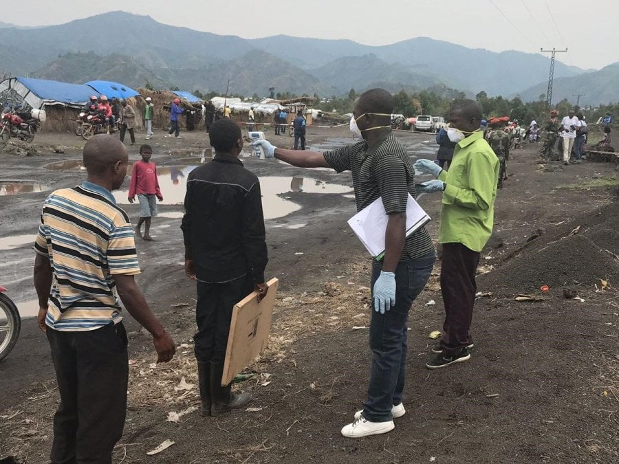 Here, in this August 2019 image, screeners use an infrared thermometer to look for signs of fever in travelers in Mubambiro, near the city of Goma, Democratic Republic of the Congo (DRC). A fever is one of the symptoms of Ebola virus disease, which Congolese and international health agencies have been battling for a year in the DRC.
