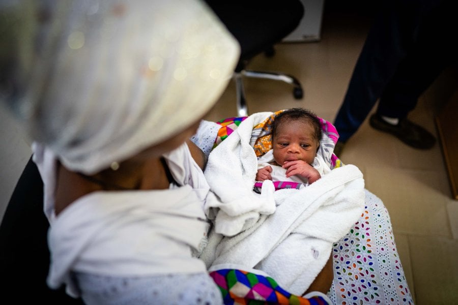 A small baby with his mother
