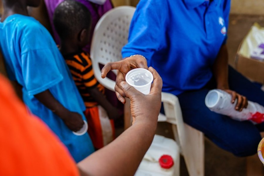  	A patient is given a does of IV and DP as part of a mass drug administration trial attempting to eradicate malaria in the region. IV (Ivemectin) kills any mosquito as it bites the patient, and the DP (Dihydroartemisinin-Piperaquine) kills the malaria parasite. Basse, The Gambia. Credit: Louis Leeson/LSHTM 