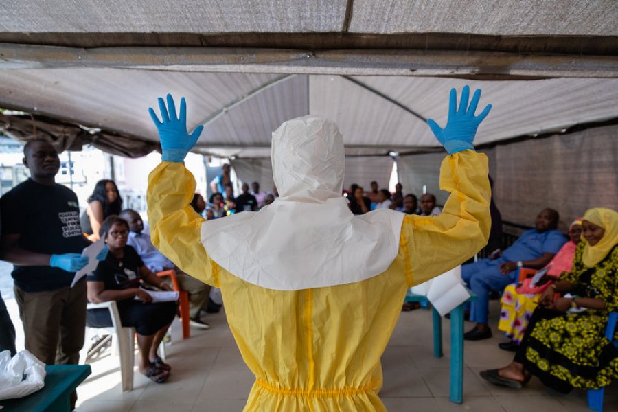 Dr Abdulmajid Suleiman Musa shows a group of NCDC staff how a correctly prepared PPE suit should look when working in a virus hit region, Keffi, Nasarawa state. Credit: Louis Leeson/LSHTM