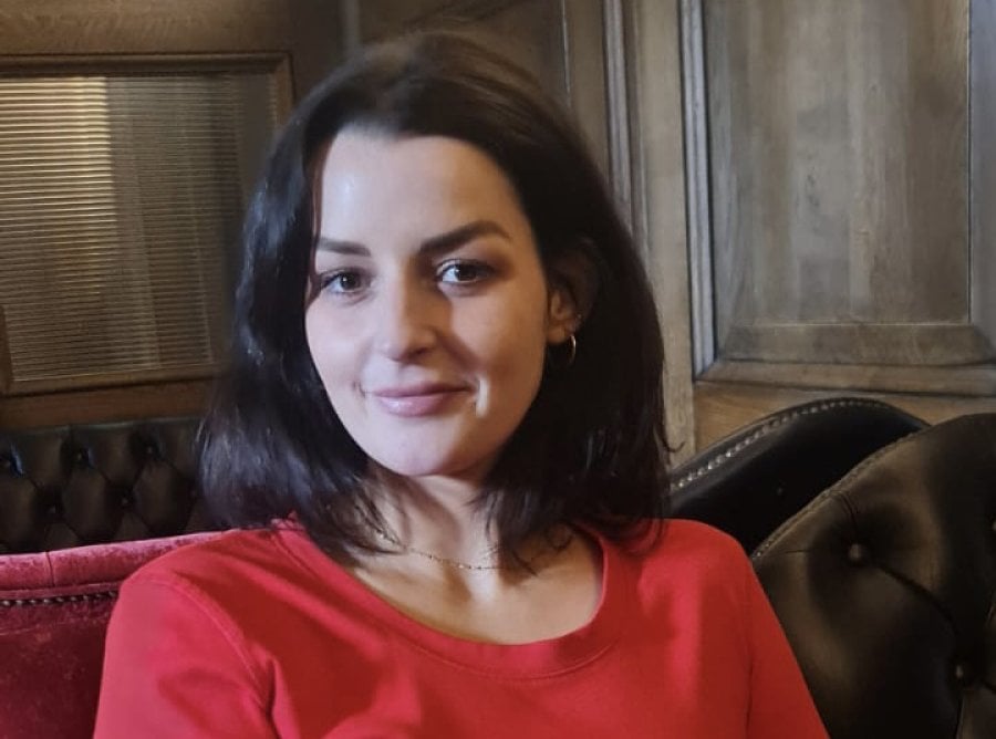 Rachel wearing a red top.