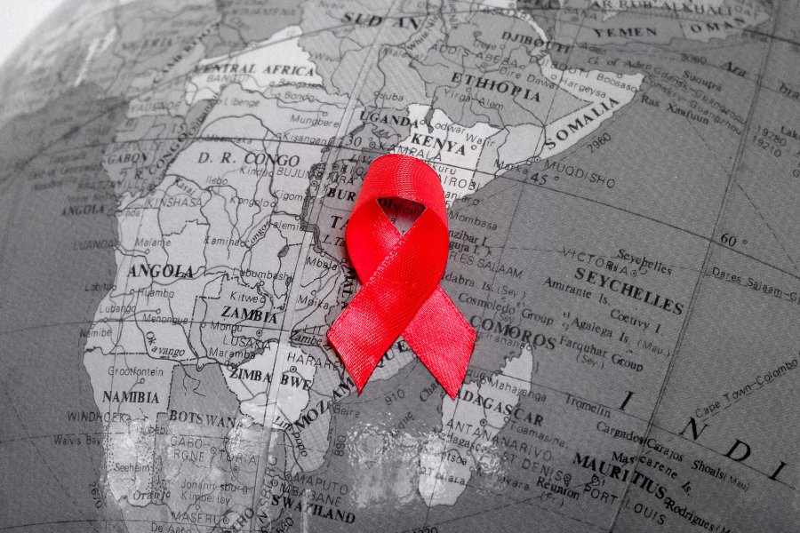Red ribbon placed on a globe model