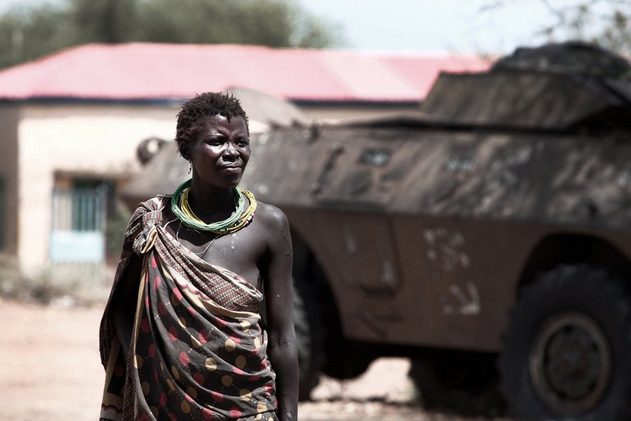 image of a woman standing in front of a military tank in south sudan
