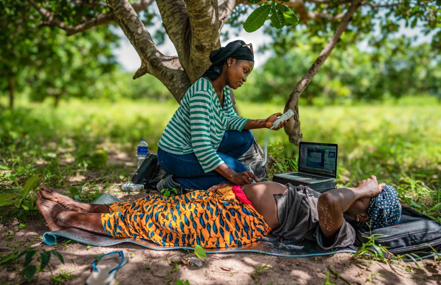 Field worker monitoring  a pregnant woman