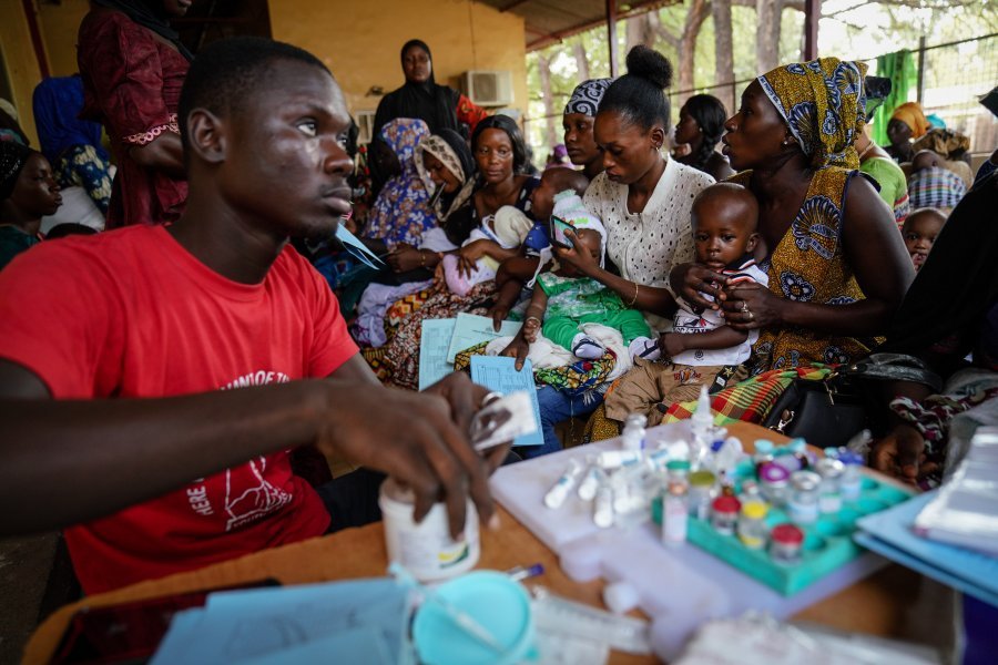 Caption: A clinician preparing a dose of vaccine in The Gambia. Credit: Louis Leeson/LSHTM