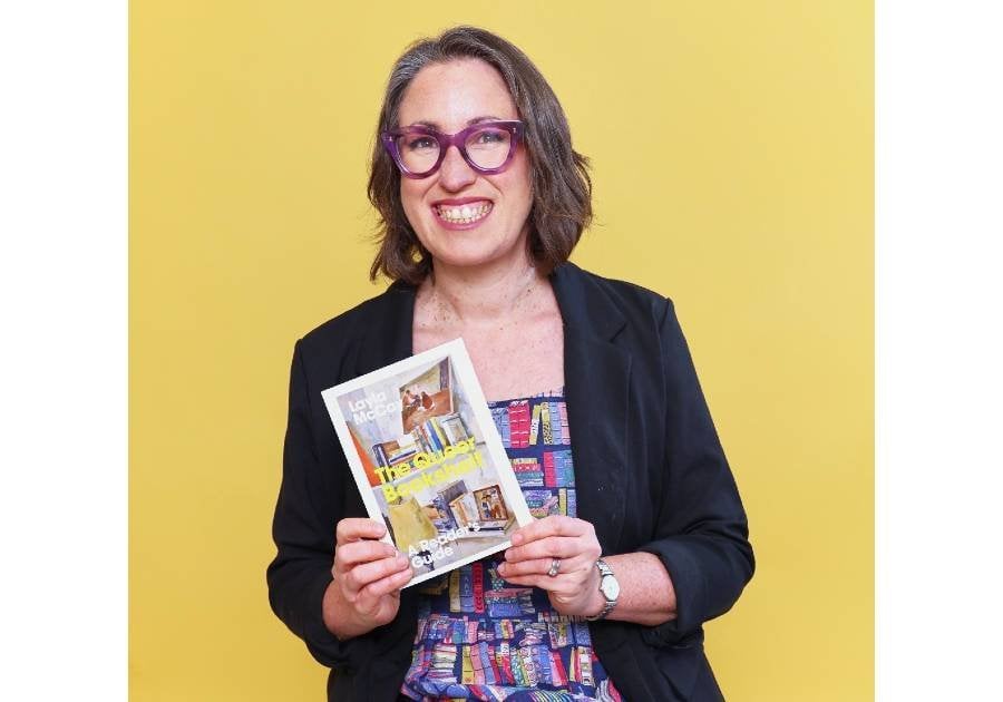 Layla McCay holding her book 'The Queer Bookshelf'