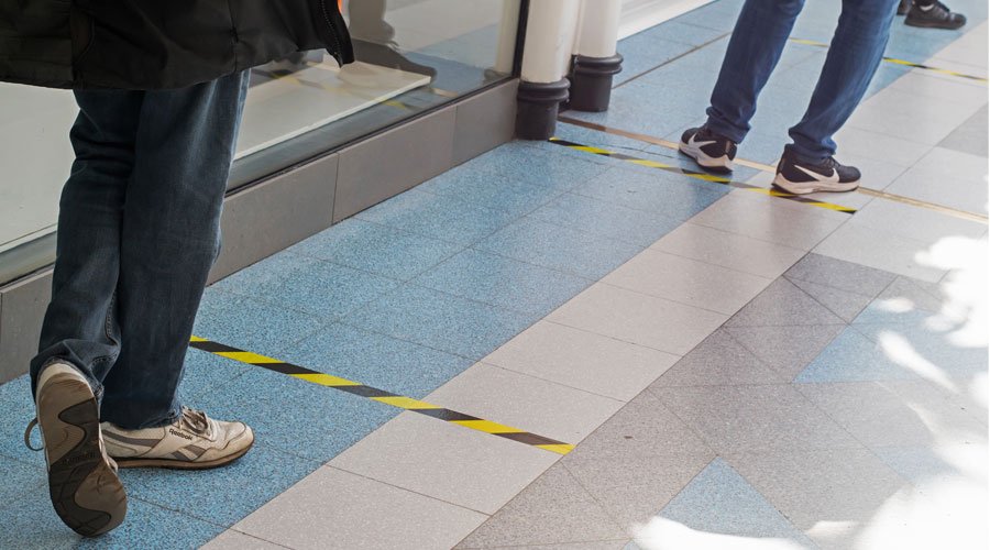 Markers on supermarket floor for customers to keep a safe distance