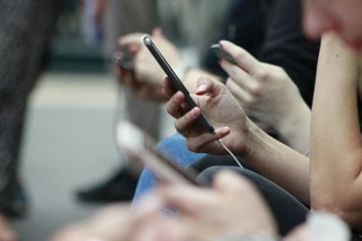 Zoomed in photo of a person holding a mobile phone