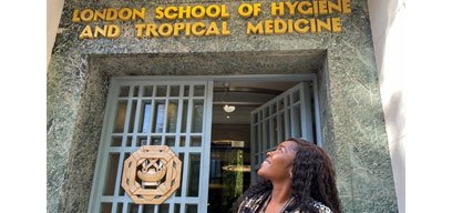 Omolayo Anjorin looking up at entrance marked 'London School of Hygiene and Tropical Medicine'