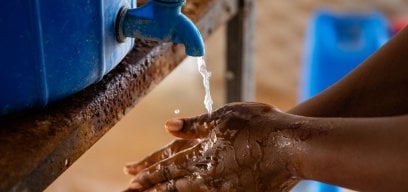 Close up of hands being washed using a faucet