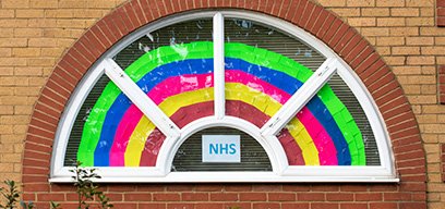 A rainbow with NHS sign in a window