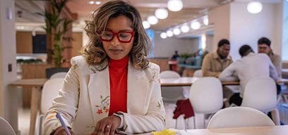 A lady sat at the table writing