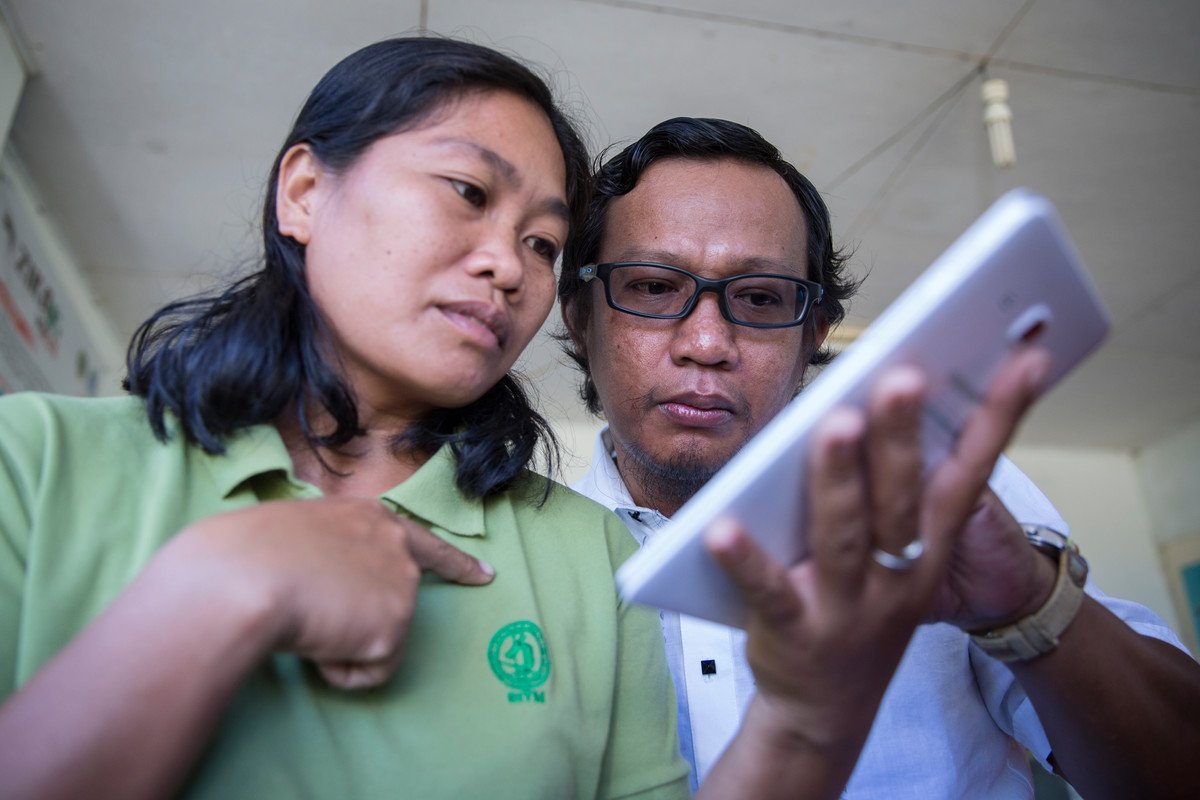 Staff from the Research Institute for Tropical Medicine, left, and ENSURE Project's stakeholder vice mayor Rowel Magrace checks the map location during a patient interview at the Rural Health Unit in Philippines. Credit: Joshua Paul/LSHTM