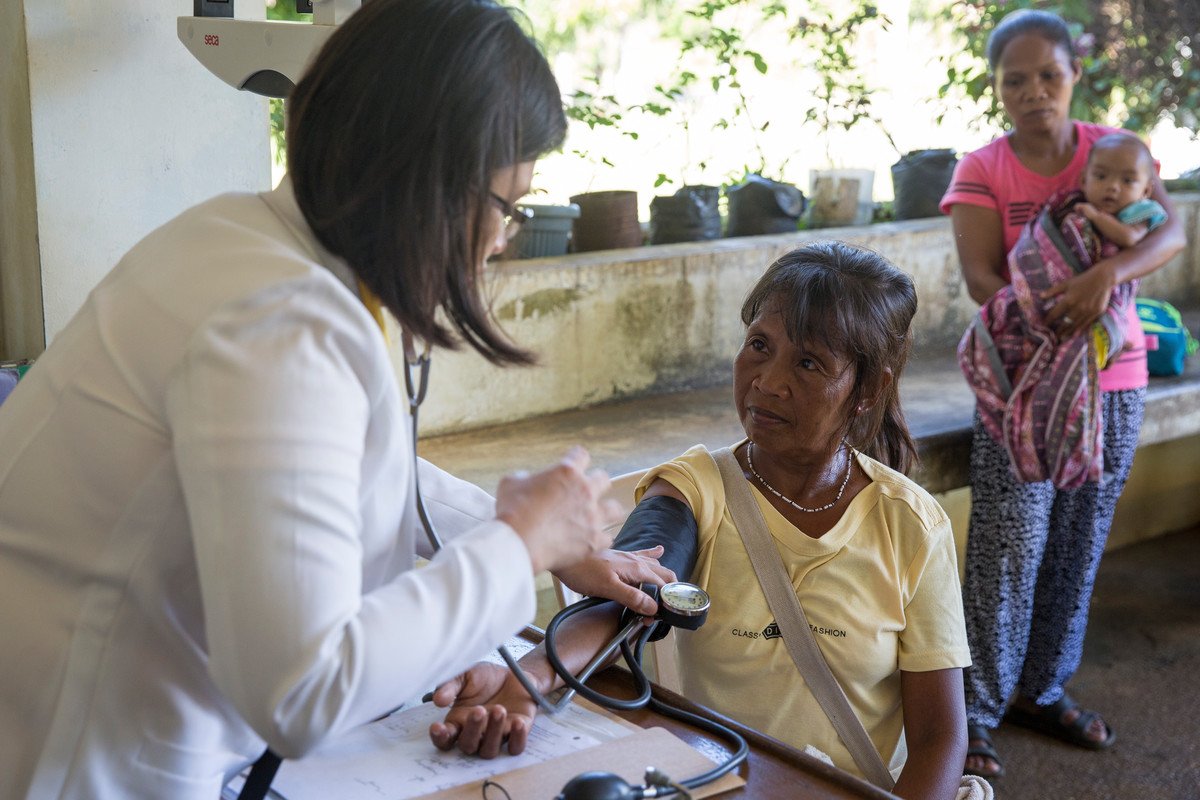 ENSURE project's stakeholder municipal health officer, Dr. Desiree Biaoco, left, tends to a Palawan native woman at the Rural Health Unit in Philippines. Credit: Joshua Paul/LSHTM