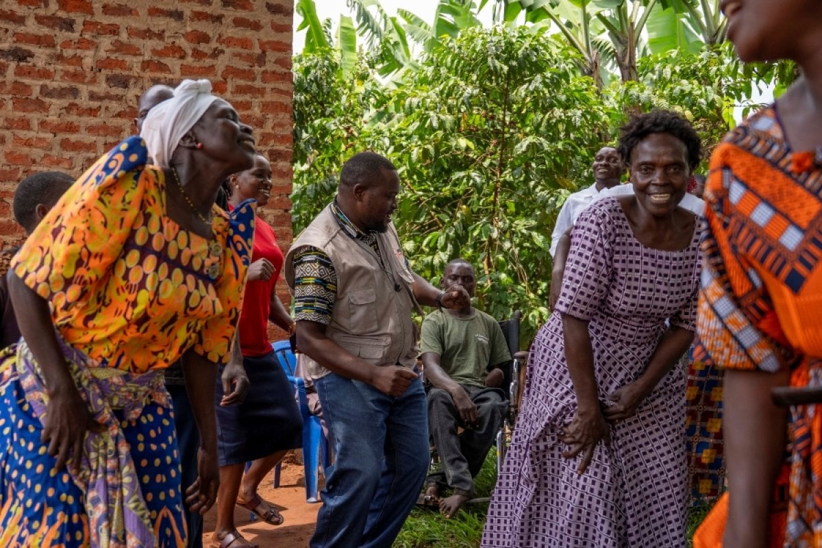 A group of PLA-D group members in Luuka district dancing in an outdoor setting