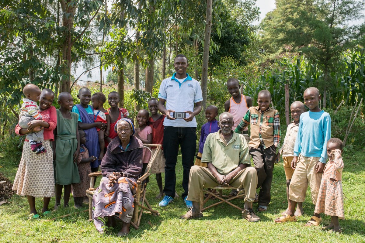 Peek staffer Cosmas Bunywera with people whose sight he has tested using Peek devices. Credit: Rolex / Joan Bardeletti