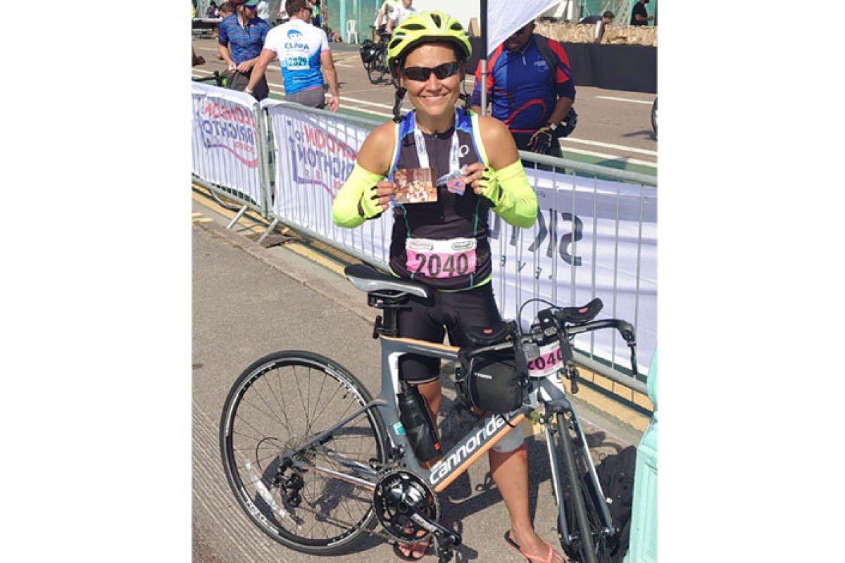 Nina Johannessen holding medal and family photo