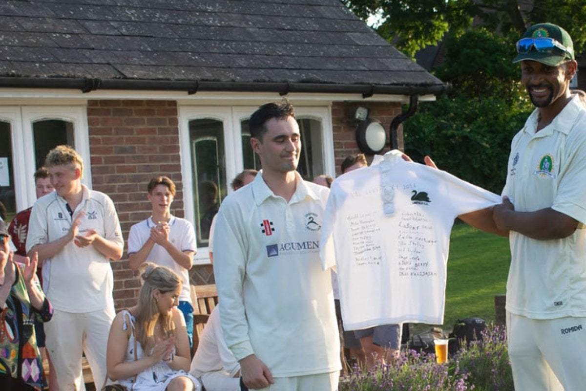Val Curtis' family and friends holding signed cricket shirt