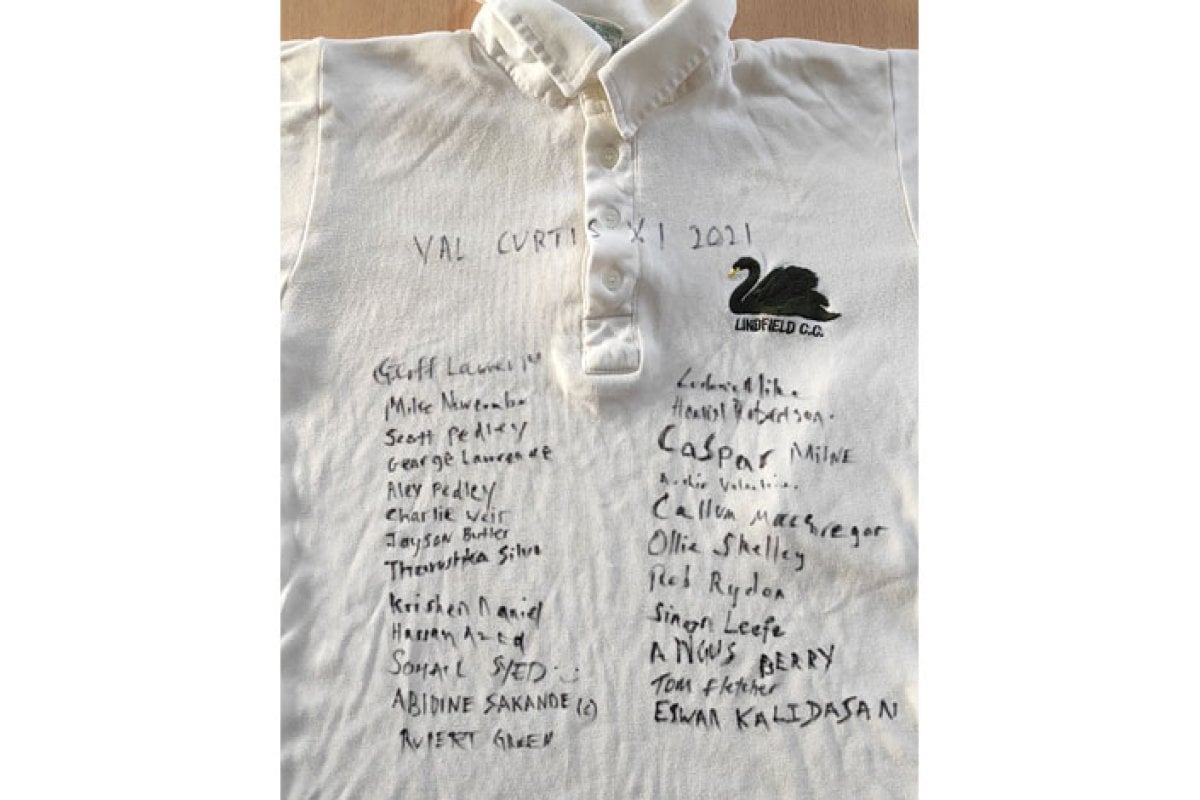 White polo shirt signed by Val Curtis' family and friends