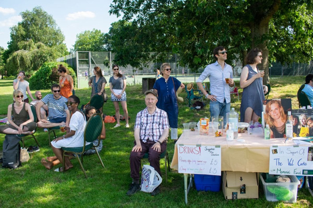 Val Curtis' family and friends sitting around table on grass