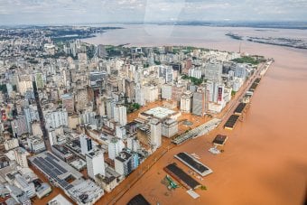 Aerial view of a high-ride city flooded with orange water