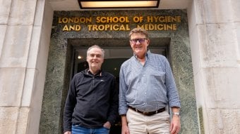 Professor David Baker (left) and Professor Colin Sutherland (right) standing at the LSHTM entrance in Keppel Street