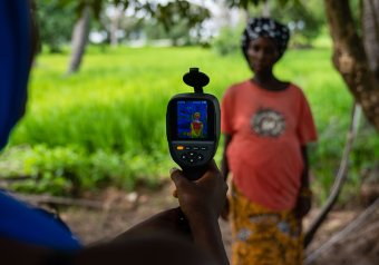 Thermal imaging camera used to measure temperature of pregnant farmer and her unborn baby, The Gambia Photo: Louis Leeson/LSHTM